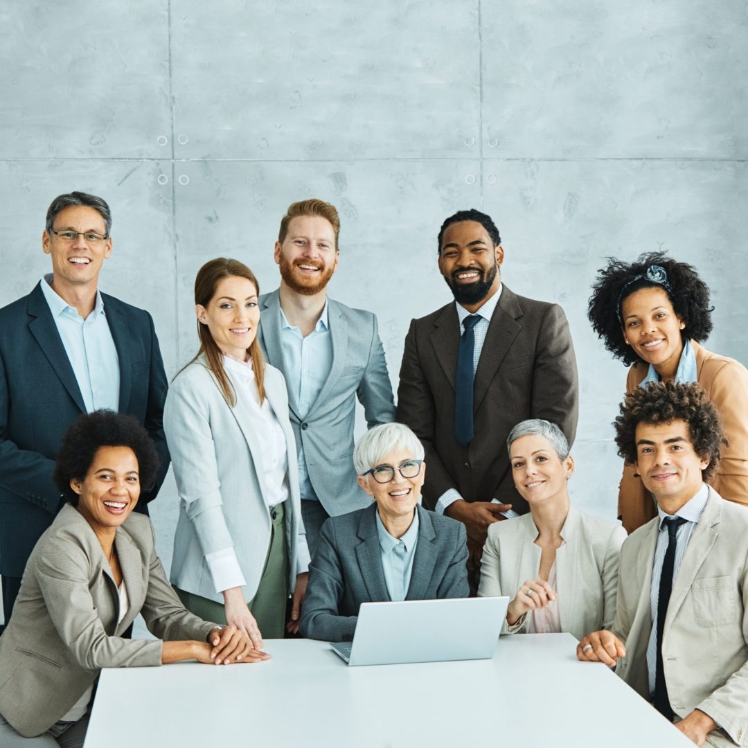 Portrait of a group of young and senior business people having a meeting in the office. Teamwork and success concept